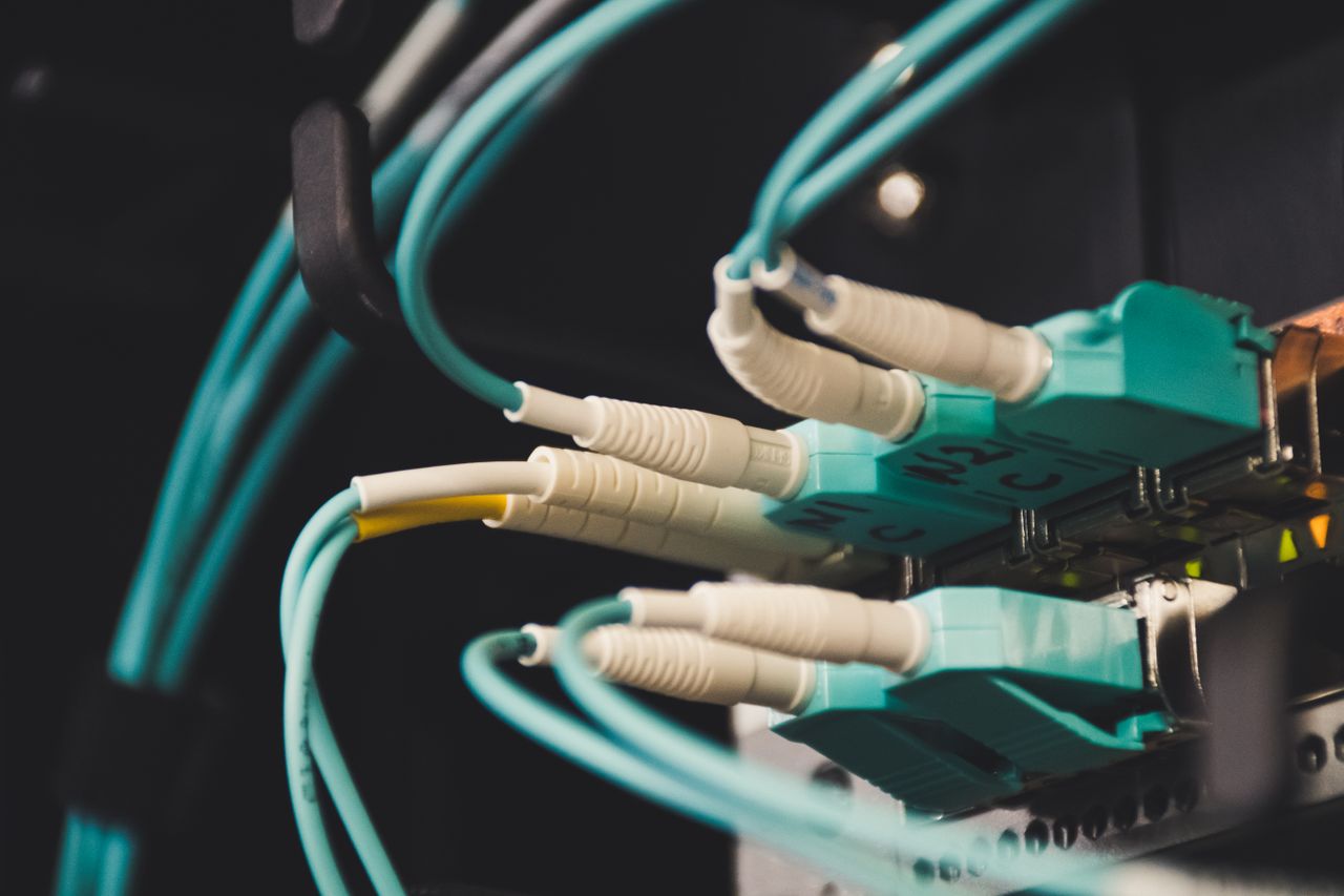 Crafting Captivating Headlines: Your awesome post title goes here Detailed view of fiber optic cables and ports in a server room, showcasing connectivity.